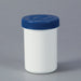 A small, white cylindrical jar with a blue lid sits on a plain gray background.
