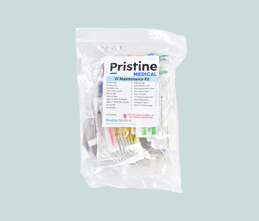 An IV maintenance kit containing various medical supplies is packaged in a clear plastic bag. The kit includes needles, syringes, tubing, and labels. It's intended for training purposes only.