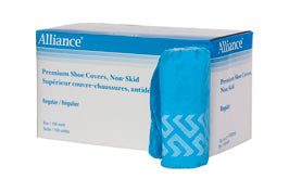 A box of light blue shoe covers sits next to two rolled-up shoe covers. The box is labeled "Alliance Premium Shoe Covers, Non-Skid." The box also indicates that they are "Regular - Régulier."