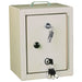 A small, beige metal cabinet with a single door sits on a white background. Two sets of keys are in the locks.
