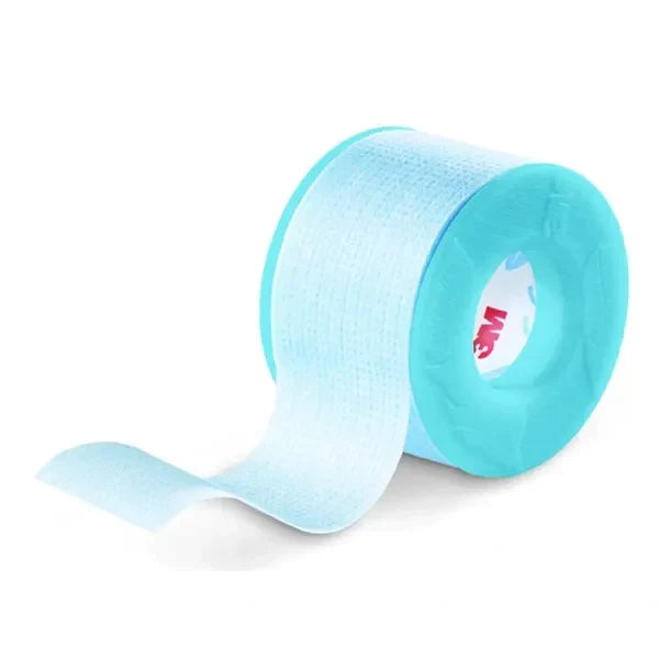 A roll of light-blue, translucent tape unwinds slightly, lying on a white surface.