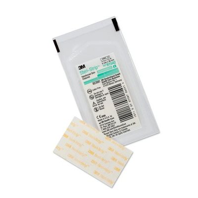 A Steri-Strip, a reinforced skin closure, rests beside its packaging. The packaging contains information including: CM8822, 6 in x 1/10 in, R1542, and various regulatory markings and barcodes.