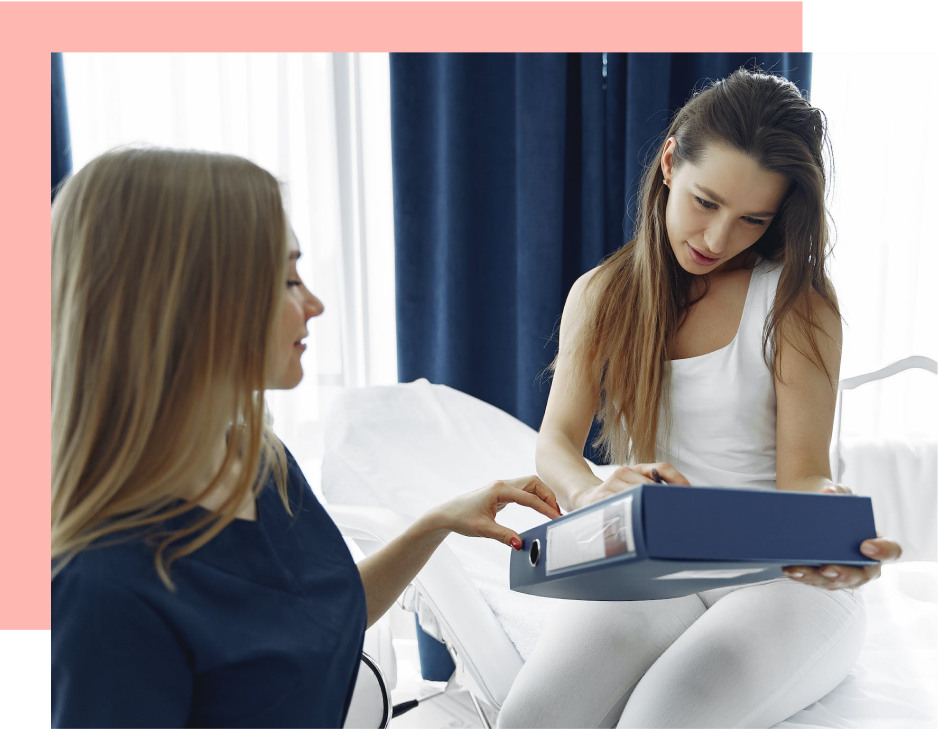A woman shows a file to a healthcare professional in a consultation room.