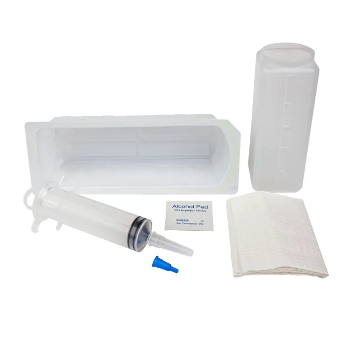 A syringe and other medical supplies, such as a container, are resting on a surface. The syringe is clear, with a blue tip.