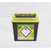 A yellow-topped, dark gray sharps container sits on a white surface. It is labeled "MEDICINAL SHARPS," "DANGER," and contains biohazard symbols. The container is for the disposal of contaminated sharps.