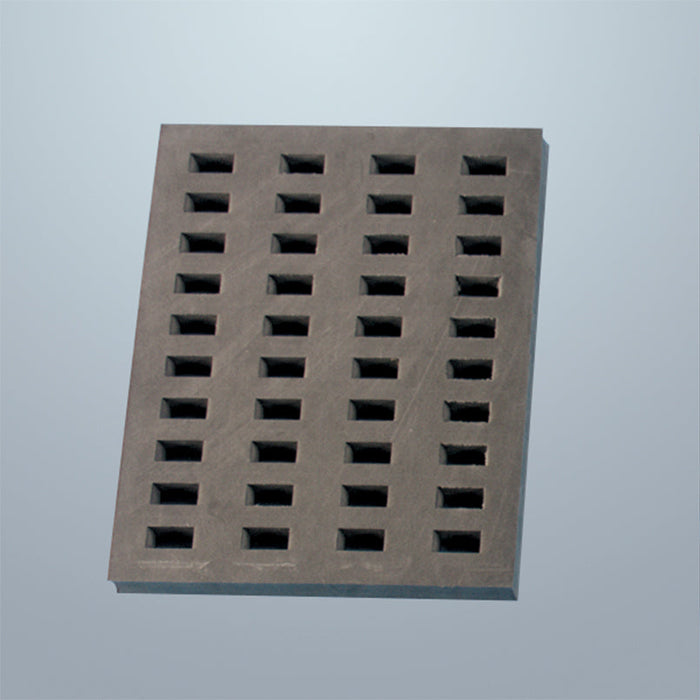 A rectangular perforated plate sits on a light-grey surface. Numerous small, rectangular holes are evenly distributed across its surface.