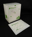 A box of gauze pads sits beside a single pad; both are white with green leaf designs and appear to be sterile.