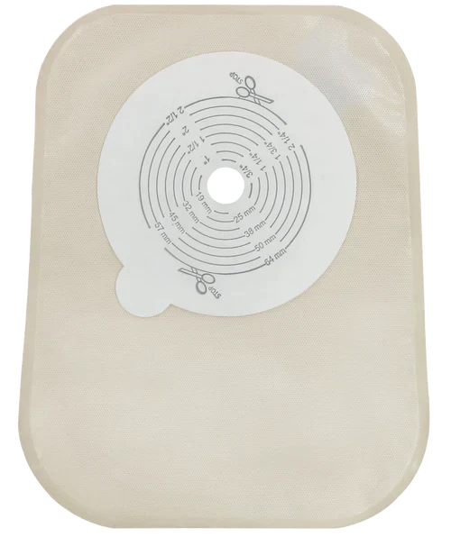 A beige, rectangular ostomy appliance features a central, circular template with millimeter markings for sizing, indicating its use for medical purposes.