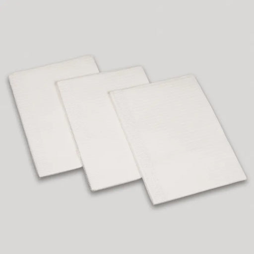 Three rectangular white pads are stacked, overlapping slightly, on a light gray surface.