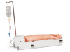 An artificial arm is receiving an intravenous drip from a fluid bag via tubing, on a training device.