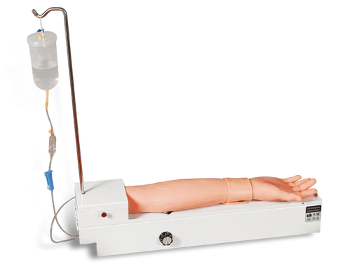 An artificial arm is receiving an intravenous drip from a fluid bag via tubing, on a training device.