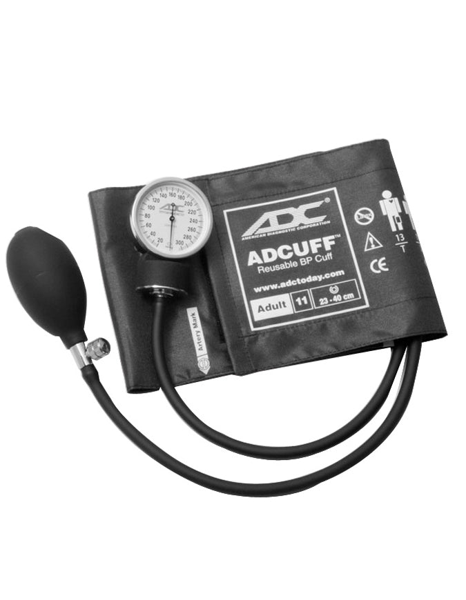A blood pressure cuff and gauge rests on a flat surface. The cuff is connected to an inflation bulb and a pressure gauge.