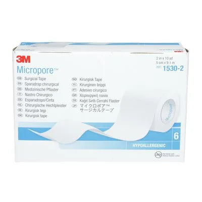 A box of 3M Micropore™ hypoallergenic surgical tape sits on a surface. The box displays the product name and various language translations of "surgical tape," along with product code 1530-2 and dimensions.