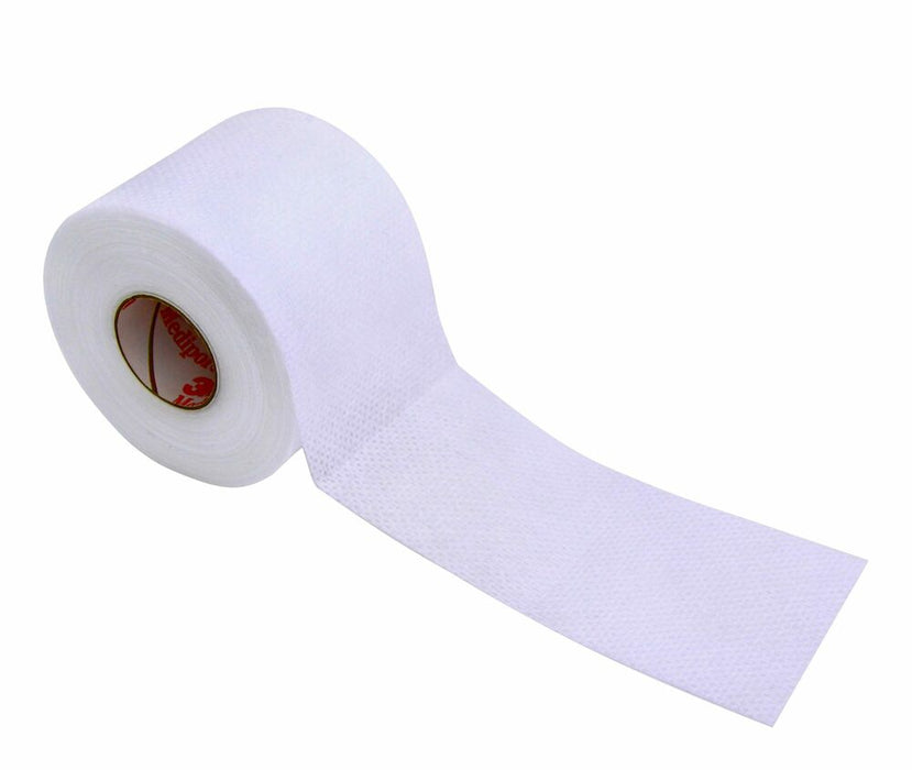 A roll of white, perforated tape unwinds onto a flat surface.