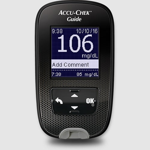 A black Accu-Chek Guide glucose meter displays a blood glucose reading of 106 mg/dL at 9:38 AM on October 10, 2016, with an earlier reading of 85 mg/dL at 7:38 AM and a prompt to add a comment.