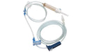 A medical intravenous (IV) set, coiled, lies on a white background. It includes tubing, a drip chamber, and connectors.