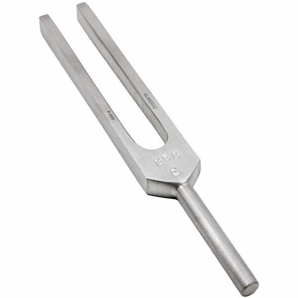 A metal tuning fork sits upright against a plain white background. It appears to be unused.