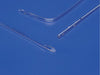 Three clear tubes, possibly catheters, lie on a blue surface. One is straight, one is curved, and one is shorter and slightly curved. They have small holes along their lengths.