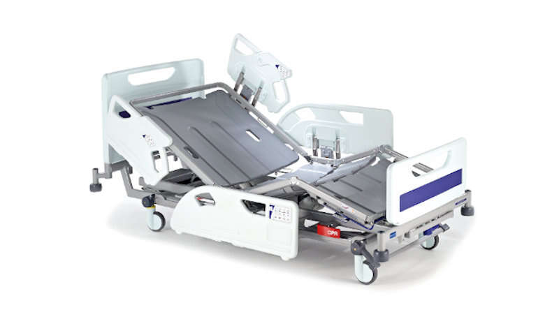 A hospital bed, in a partially raised position, sits on a white background.