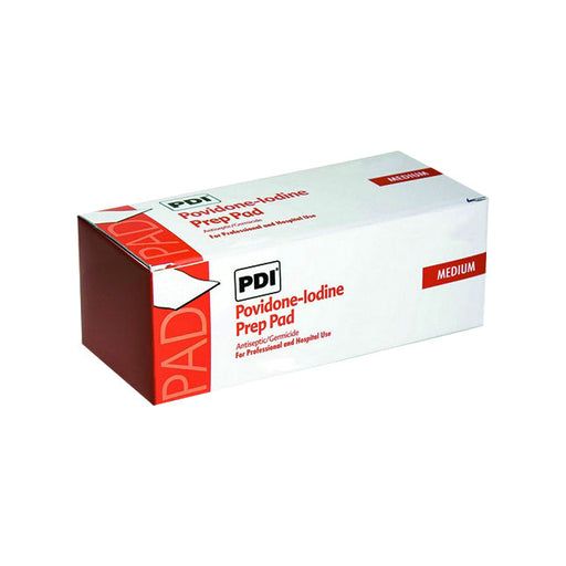 A box of medium Povidone-iodine Prep Pads sits on a surface. The pads are antiseptic/germicidal for professional and hospital use.