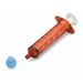 A small, reddish-brown syringe rests on a white surface; a light blue sphere lies nearby.