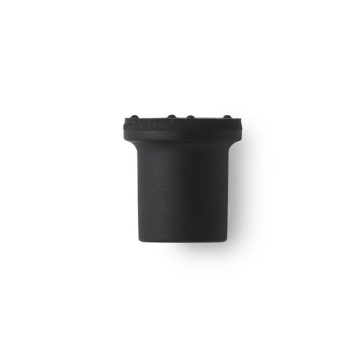 A black cylindrical ferrule sits on a white background. It has a textured top.