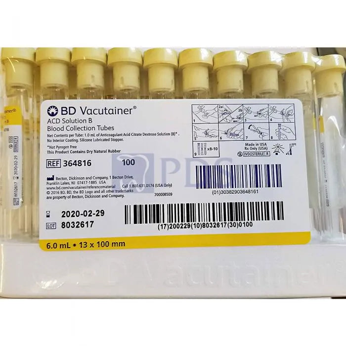 A box of 100 BD Vacutainer ACD Solution B blood collection tubes sits in an undefined setting. The tubes are ready for use, and the box contains relevant product information, including the lot number 8032617 and expiration date 2020-02-29.