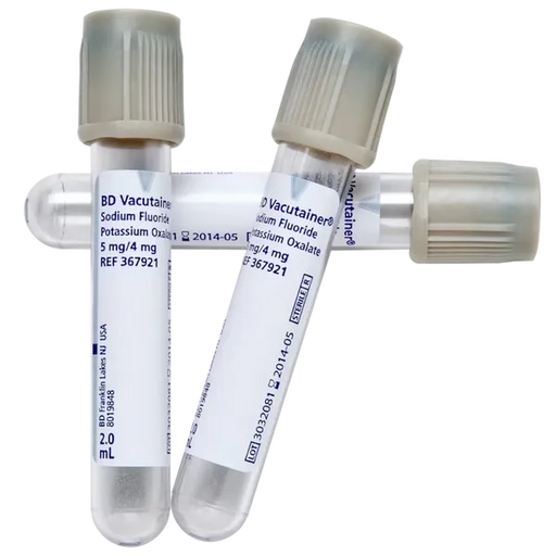 Three BD Vacutainer tubes, containing sodium fluoride and potassium oxalate, lie on a surface. Each tube is labeled with lot numbers and expiration dates (2014-05). They are 2.0 mL.