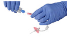 Gloved hands assemble a catheter. A needle and a connector are being joined. The setting is a sterile environment.