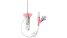 A catheter, assembled, is shown against a black background. The components include a needle, tubing, and a connector.