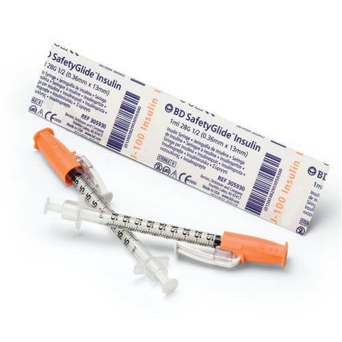 Two insulin syringes, with safety features and orange covers, rest on a white surface next to their packaging. The packaging labels read: "BD SafetyGlide Insulin 1ml 28G 1/2 (0.36mm x 13mm)" and "J-100 Insulin" multiple times. REF 305930 is also printed.