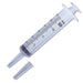 A clear plastic syringe, measuring 20 cc, lies on a white background with its tip and cap detached. The markings indicate measurements in milliliters.