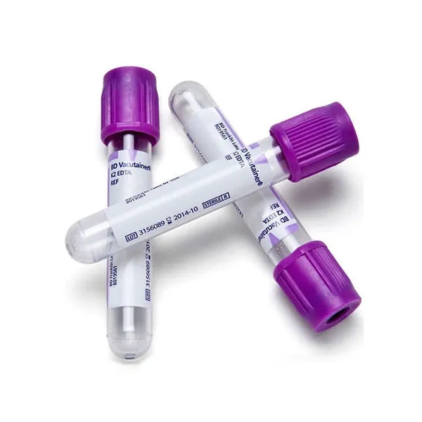 Three purple-topped vacutainer tubes lie on a white surface; two are partially overlapping the third. The tubes contain blood collection additives; labels show lot and expiration details.