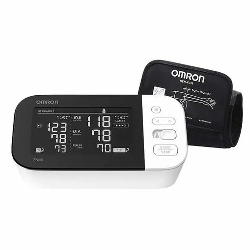 An Omron HEM-FL31 digital blood pressure monitor displays readings; a cuff is attached. The device shows systolic, diastolic, and pulse readings.