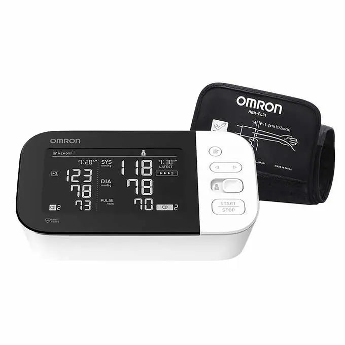 An Omron HEM-FL31 digital blood pressure monitor displays readings; a cuff is attached. The device shows systolic, diastolic, and pulse readings.