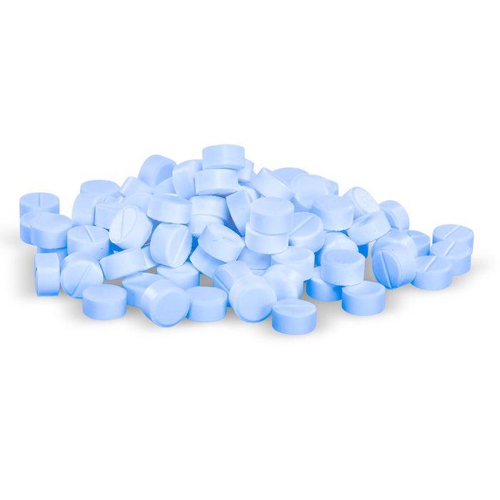 Light blue pills are piled loosely on a white background.