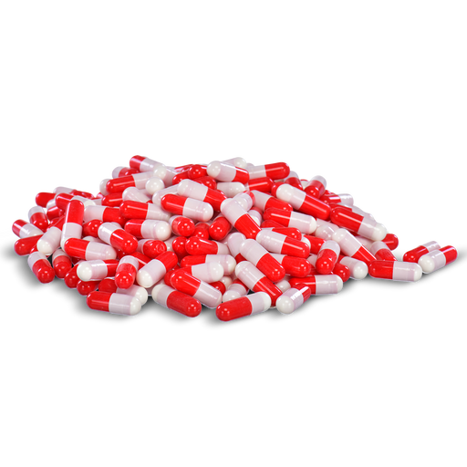 Red and white capsules are piled against a black background.