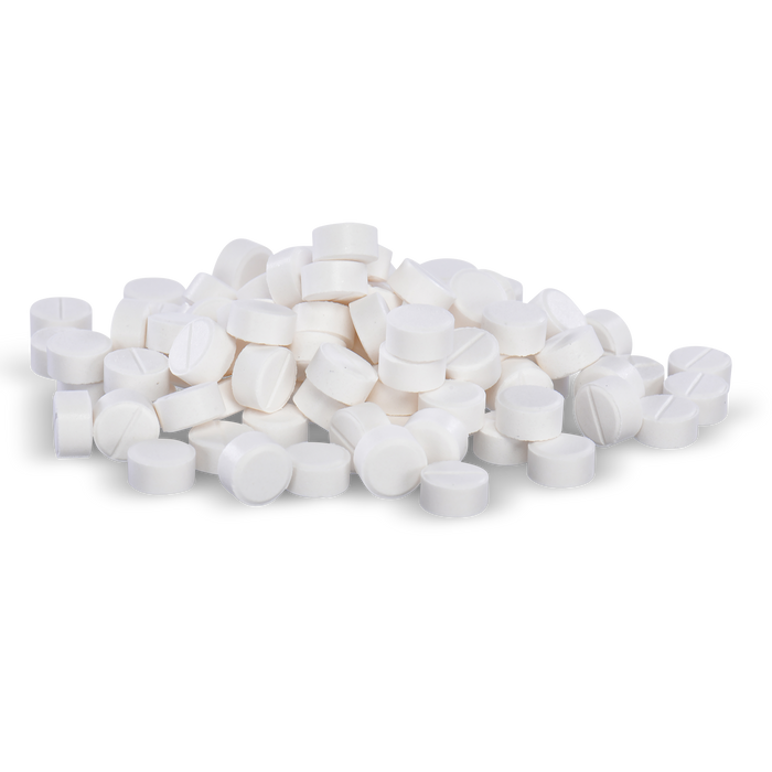 Many round, white pills are piled loosely on a black background.