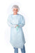 A person, wearing a light-blue disposable gown, gloves, and a bouffant cap, stands against a white background.