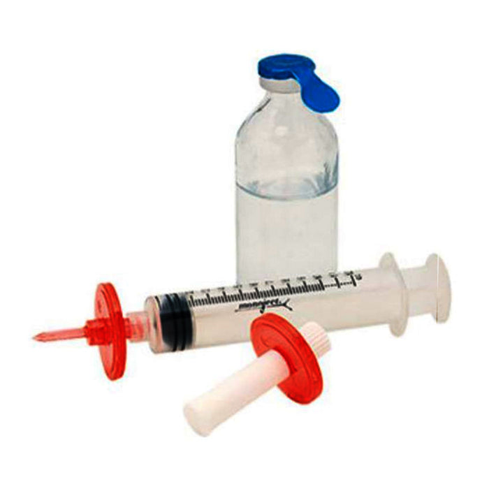 A syringe and vial rest on a surface. The syringe is clear with red and white attachments. The vial is clear glass with a blue flip top.