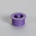 A purple plastic stopper sits on a light gray surface. It features a central, small projection and a ribbed base.