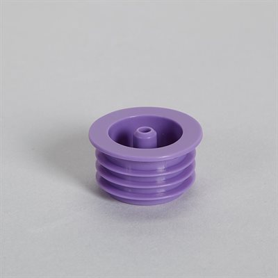 A purple plastic stopper sits on a light gray surface. It has a central, slightly recessed opening and is ribbed at its base.