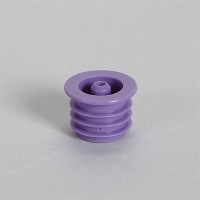 A purple plastic stopper sits on a light gray surface. It has a central opening and a ribbed base.