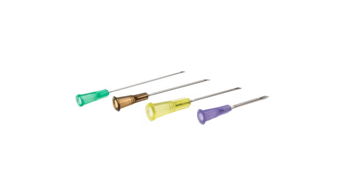 Four hypodermic needles, with varying colored hubs, lie on a white background.