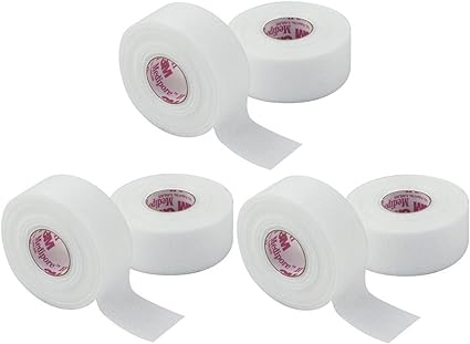 Four rolls of white 3M Medipore tape are displayed. The rolls are partially unrolled, showing the adhesive side. They are arranged on a plain white background.