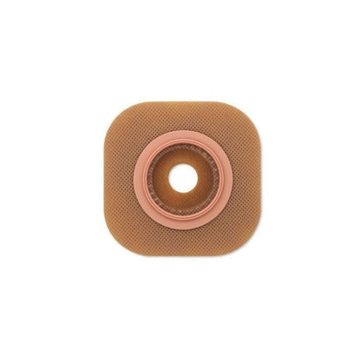 A beige, square ostomy wafer with a central, ringed aperture sits on a white background.