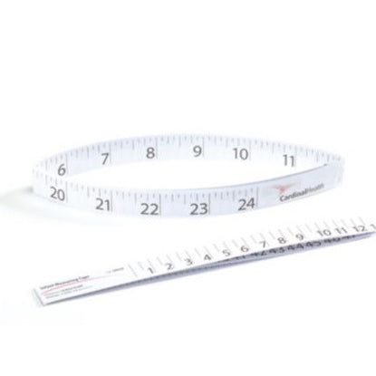 A flexible, circular measuring tape, printed with centimeters, lies on a surface; a smaller, straight measuring tape is also present.