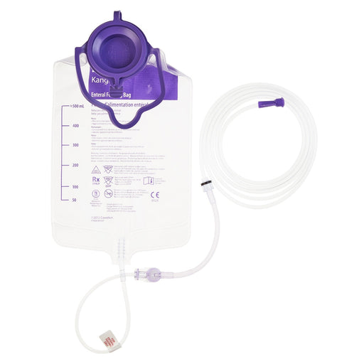 A breast milk collection bag hangs from a purple top, connected to a tube, against a white background.