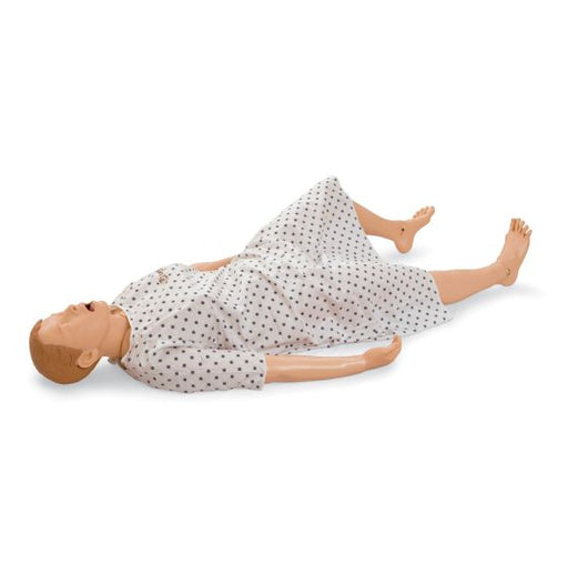 A medical mannequin lies supine on a white surface, wearing a dotted gown.