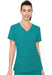 A woman, wearing a teal V-neck scrub top, stands against a white background.